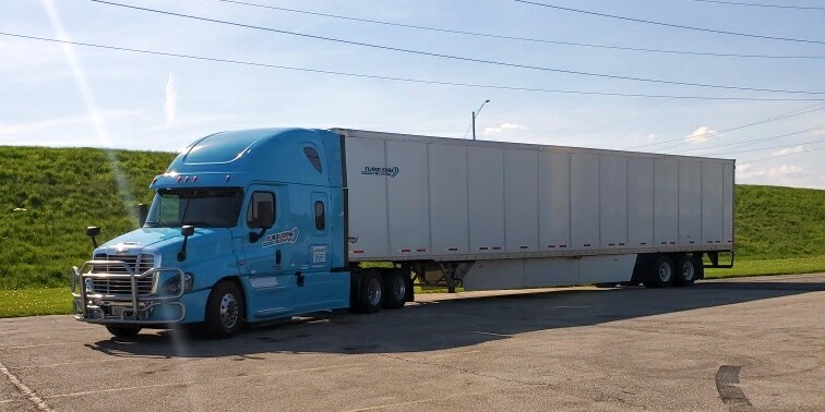 Turquoise cab with dry van trailer.